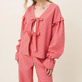 Red and white checkered pajama set on a plain background